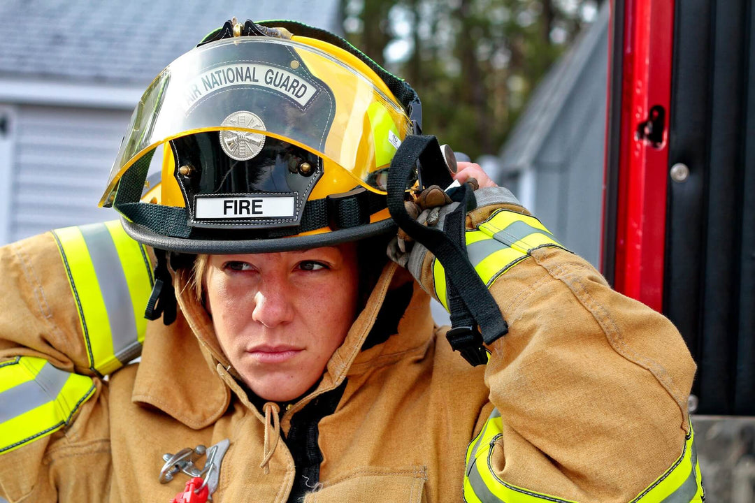 Female firefighter adjusting hat