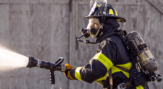 Firefighter in Turnout Gear with Fire Nozzle